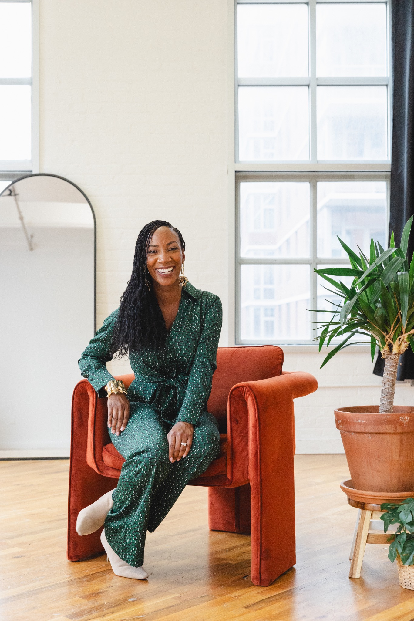 Jackie smiling in a green suit